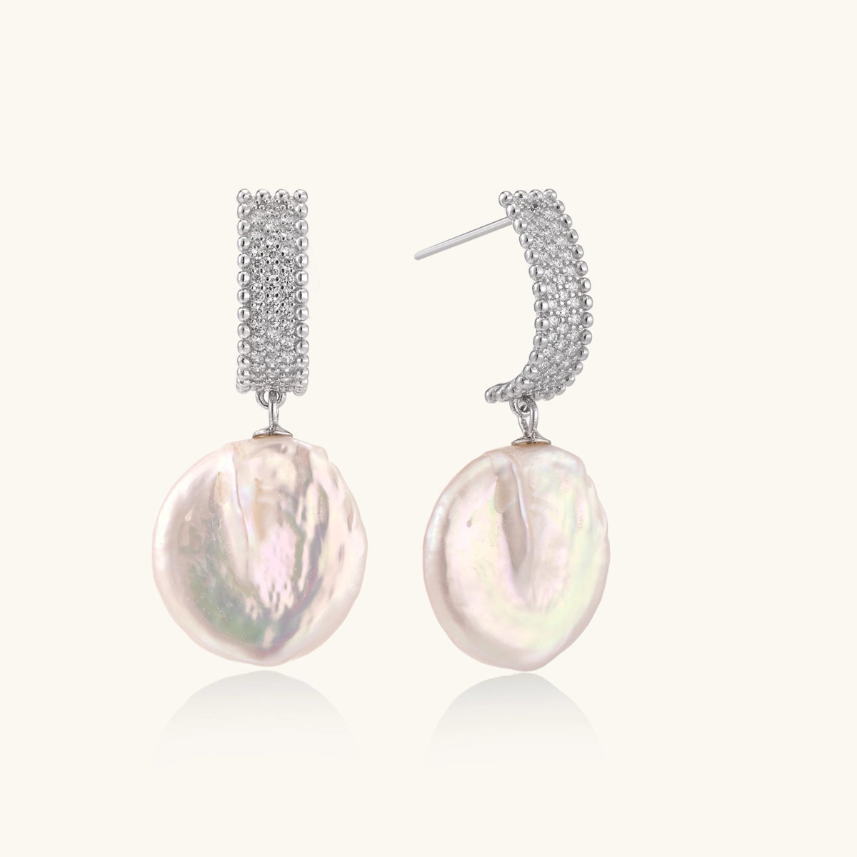 Rhodium-plated silver curved stud with pave stones and baroque pearl drop on white background