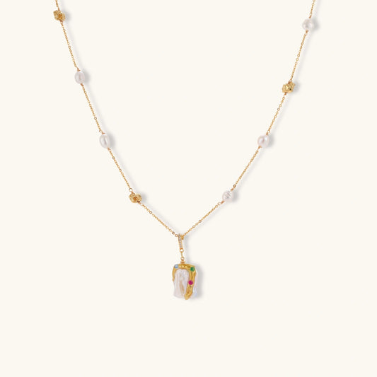 Delicate 18k gold-plated chain with baroque pearls and colorful enamel pendant featuring blue, pink accents on cream background.